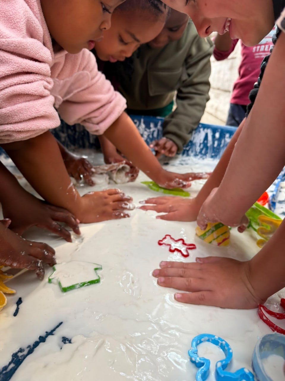 Children exploring textures together during a sensory play activity